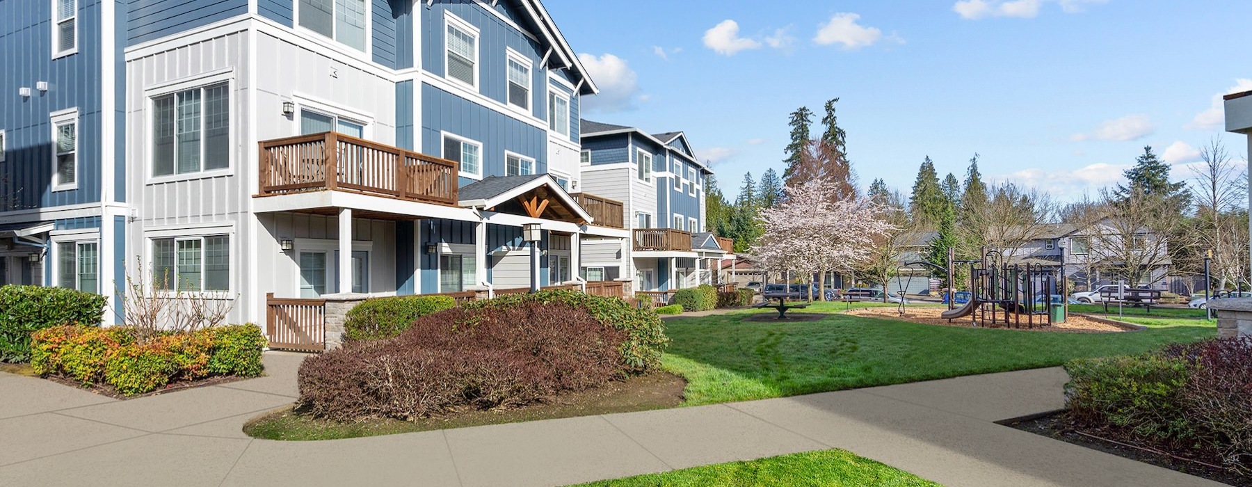 an apartment building with grass