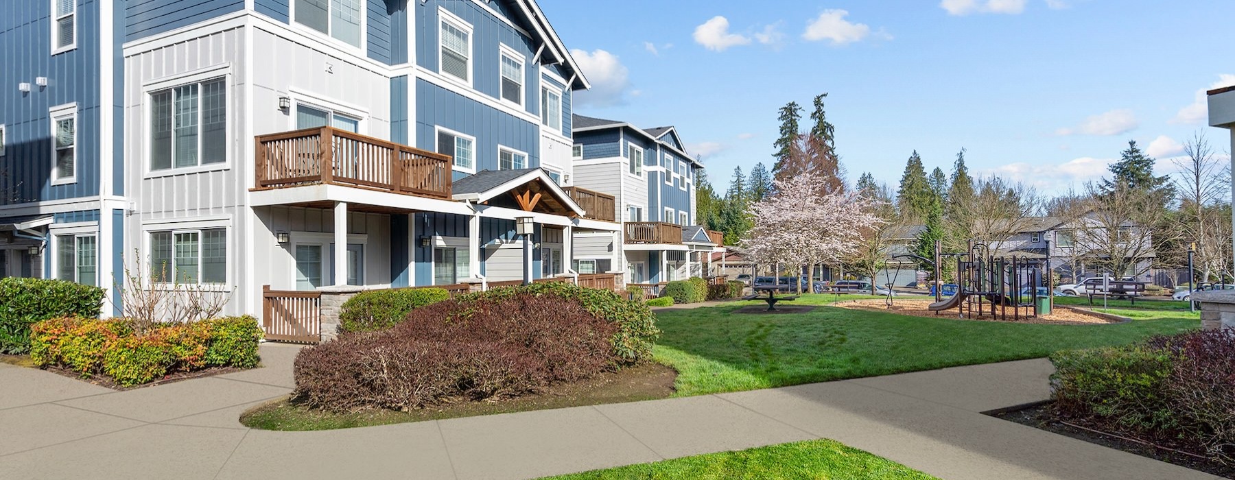 an apartment building with grass